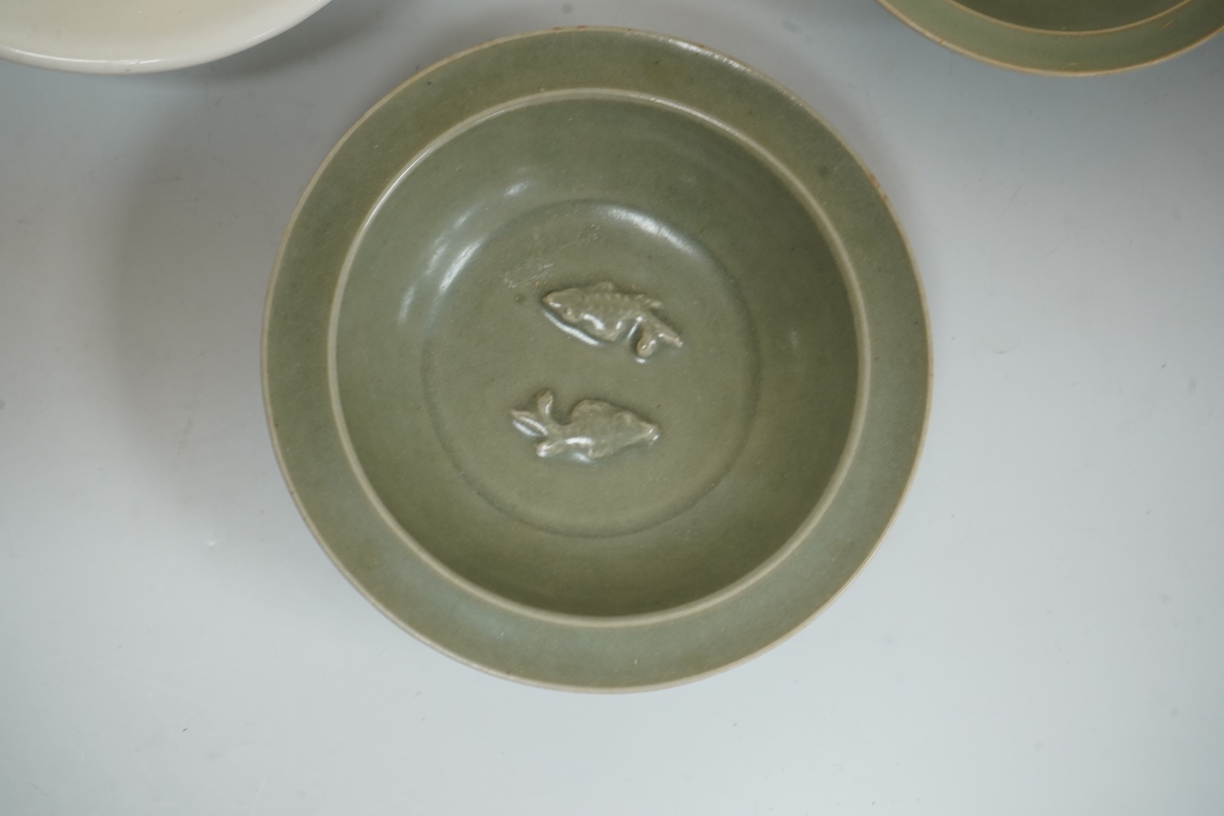 A Chinese celadon glazed twin fish dish, another similar and a white glazed bowl, largest 13.5cm